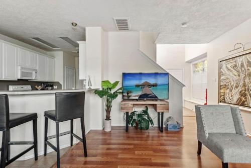 a kitchen and living room with a table and chairs at Amazing house in Woodlands fully equipped for 6 in Conroe