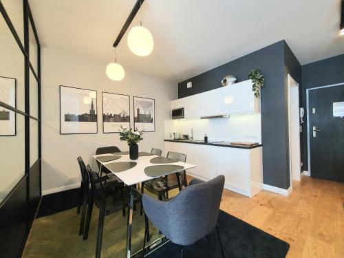 a kitchen and dining room with a table and chairs at Old Town Residence Gdansk in Gdańsk