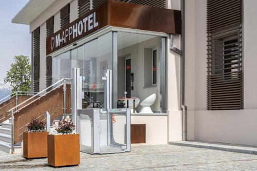 a store front with a sign that reads multipurpose at M-APPHOTEL in Benna