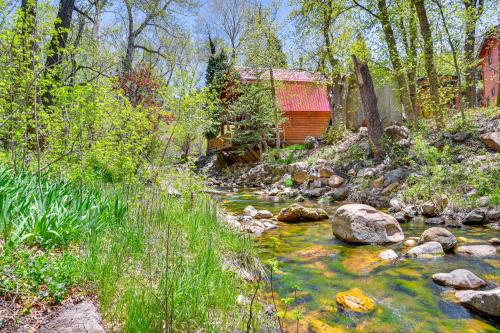 a stream in front of a cabin with a red barn at Creekside Cabin Retreat with Private Deck in Payson in Payson