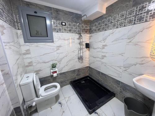 a bathroom with a toilet and a sink at A luxury apartment fully nile view -Downtown Cairo in Cairo
