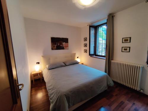 a bedroom with a bed and a window at Casa Relax in Bellano