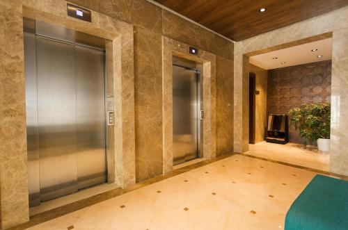 an empty lobby with a glass elevator in a building at Fesa Business Hotel in Gebze