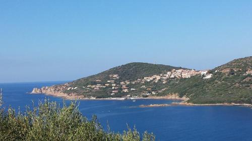 a view of a large body of water with houses at Bel Mare in Cargèse