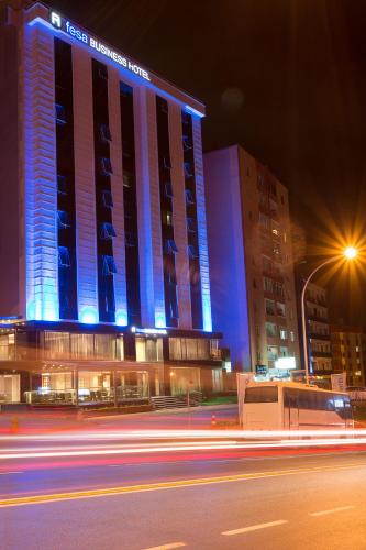 a tall building with blue lights on it at night at Fesa Business Hotel in Gebze
