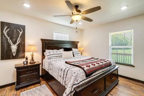 a bedroom with a bed and a ceiling fan at Arkansas Retreat with Deck, Fire Pit and Mtn Views! in Jasper