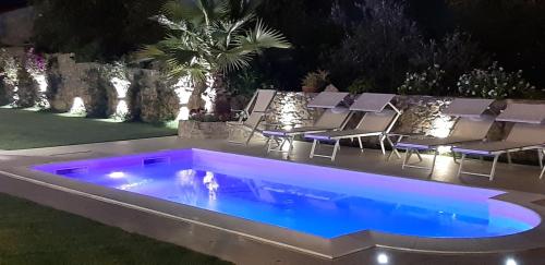 a swimming pool in the middle of a yard at night at Dreams Guest House in La Spezia