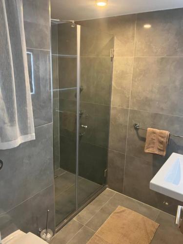 a shower with a glass door in a bathroom at Duplex Penthouse Qawra Malta in St. Paul's Bay