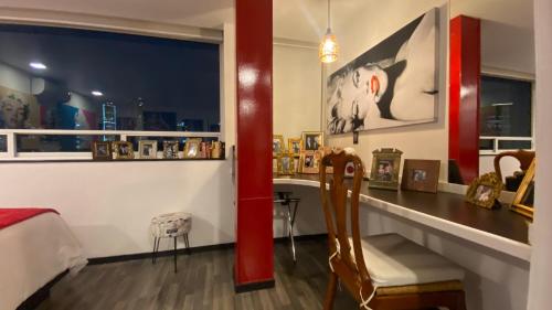 a room with a table and a chair and a desk at Hotel Black Boutique in Mexico City