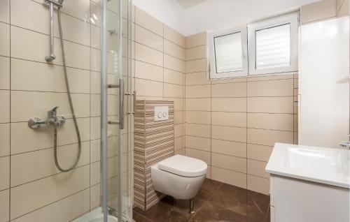 a bathroom with a shower and a toilet and a sink at Stunning Apartment In Crikvenica With Kitchen in Crikvenica