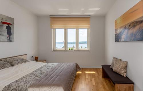 a bedroom with a bed and a window at Stunning Apartment In Crikvenica With Kitchen in Crikvenica