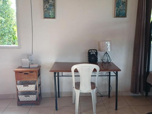 a desk with a chair and a table with a camera at Hotel Cabañas Casita La Ermita in San Carlos