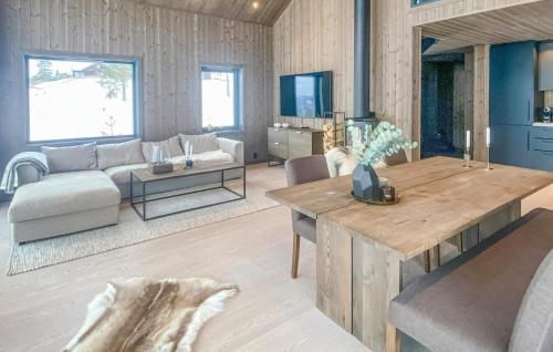 a living room with a couch and a table at Awesome Home In Hønefoss With Wifi in Hønefoss