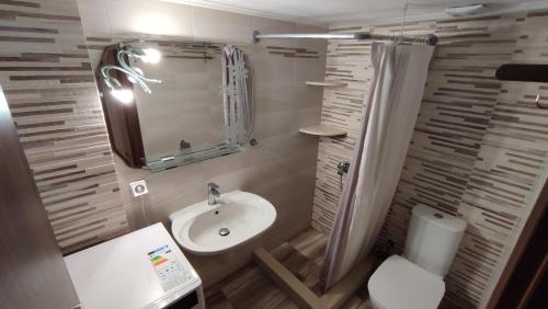a bathroom with a sink and a toilet and a mirror at Lesvos Tavari bay 2 in Tavari