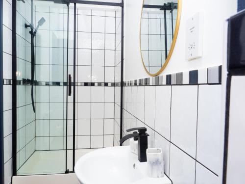 a bathroom with a sink and a shower at Ramsgate Boutique Apartment in Ramsgate