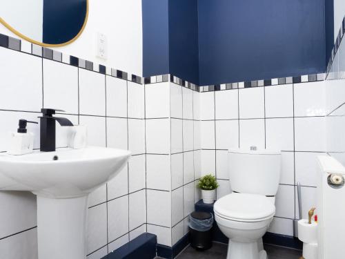 a bathroom with a white toilet and a sink at Ramsgate Boutique Apartment in Ramsgate