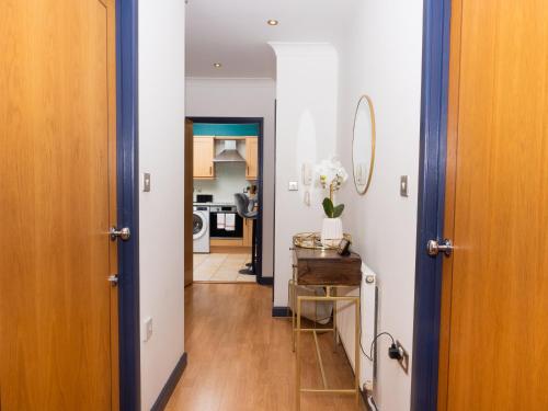 a hallway with a door open to a kitchen at Ramsgate Boutique Apartment in Ramsgate