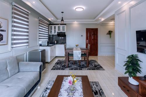 a living room with a couch and a table at Lavermo Hotel Apartments in Kampala