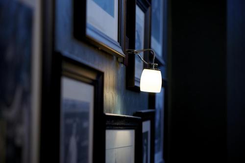 a light on the side of a building with windows at The Lodge Hotel - Putney in London