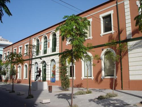 a building with a person on a bike in front of it at Experiencia Premium en la Esencia de Denia in Denia