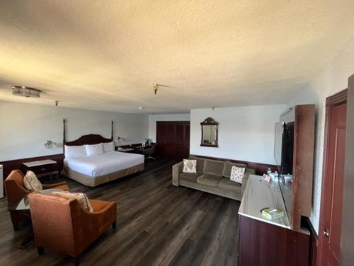 a hotel room with a bed and a couch at The New Pioneer in Laughlin