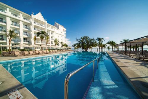 a swimming pool in front of a hotel at Riu Ocho Rios - All Inclusive in Ocho Rios