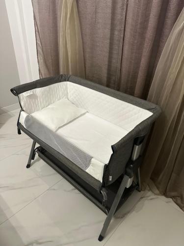 a small bed in front of a curtain at Sea & Joy House in Ialyssos