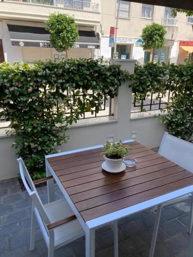 a wooden table and chairs on a patio at Apartamentos Turísticos La Plaza in Chipiona