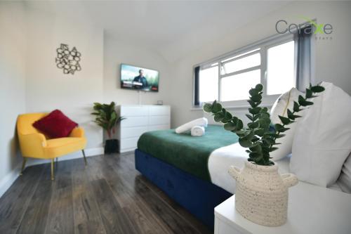 a bedroom with a bed and a vase with a plant at 3 Bedroom Tranquil Heaven for Contractors and Families Choice by Coraxe Short Stays in Tilbury