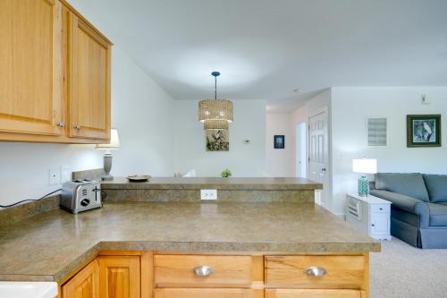 a kitchen with a counter top and a blue couch at Buxton Vacation Rental with Shared Canal Access! in Buxton