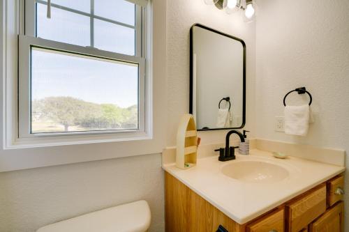 a bathroom with a sink and a window at Buxton Vacation Rental with Shared Canal Access! in Buxton