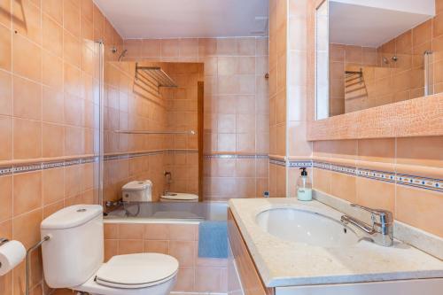 a bathroom with a toilet and a sink and a tub at Can Marineta in Palma de Mallorca
