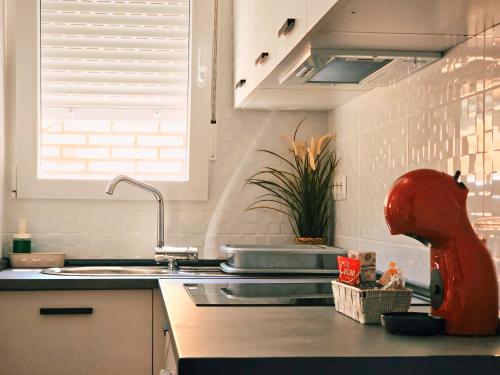 a kitchen with a sink and a counter top with a faucet at La casita de Mercedes in Málaga
