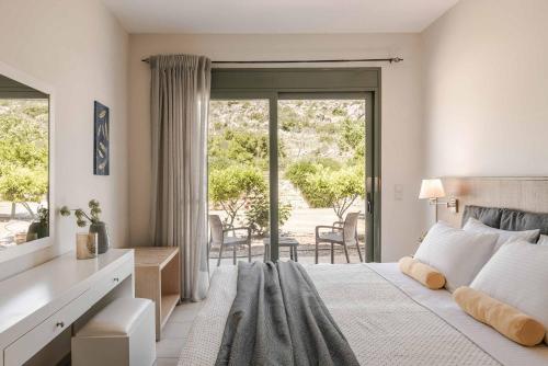 a bedroom with a large bed and a sliding glass door at Villa Eva Skala in Skala Kefalonias