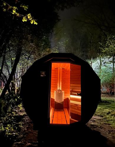 a small house with a light in the dark at SKRZAT in Tumlin