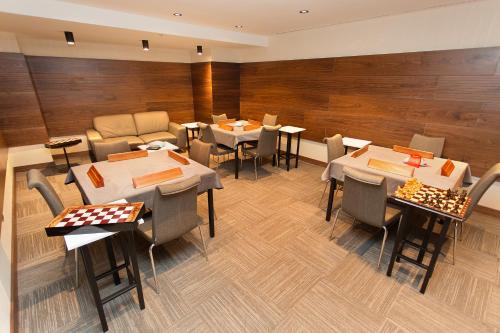 a restaurant with tables and chairs in a room at Fesa Business Hotel in Gebze
