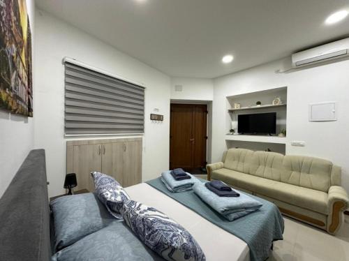a living room with a bed and a couch at Villa For You in Mostar