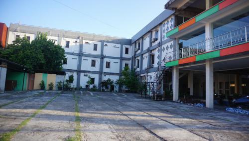 an empty parking lot in a building with buildings at New Wijaya Hotel in Yogyakarta
