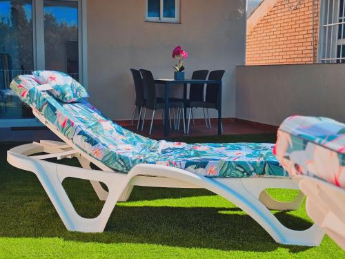 a chair with a cover sitting on the grass at La casita de Mercedes in Málaga