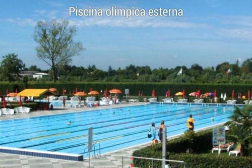 a large swimming pool with people standing around it at ERMAN HOUSE Perla nera veneziana in Dolo
