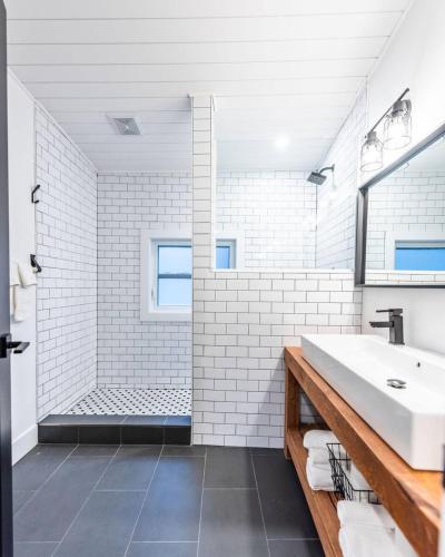 a white bathroom with a sink and a shower at The Downtown Nordic Nest in St. John's