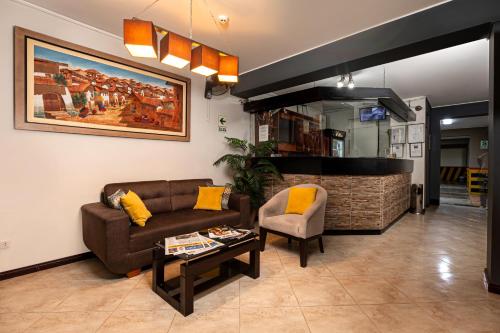 a living room with a couch and a table at Hotel Bohemia in Lima