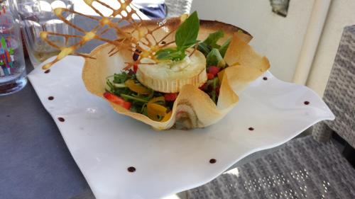 a sandwich on a white plate on a table at Bel Mare in Cargèse