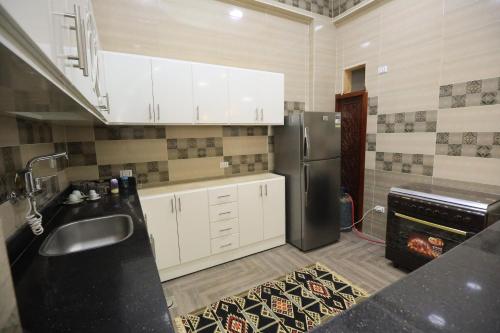 a kitchen with a sink and a refrigerator at Ramsses Palace in Luxor