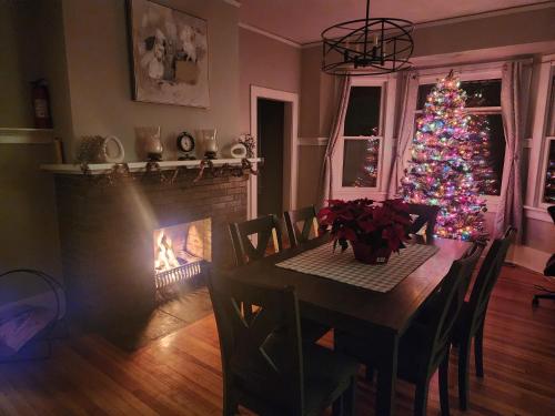 a christmas tree in a dining room with a table and a fireplace at Historic Home w/Pikes Peak Views in Colorado Springs