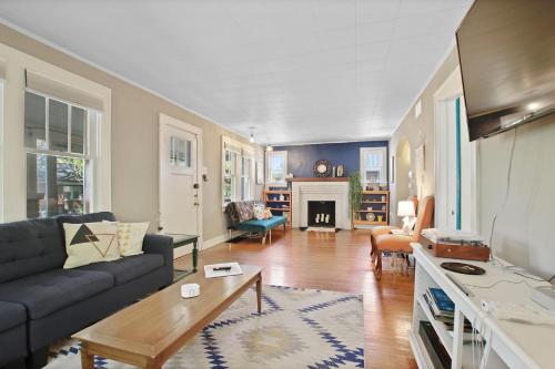 a living room with a couch and a table at Bohemian Bungalow Pac-Man, walk downtown, pet friendly in Columbia