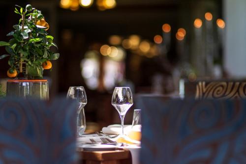 a table with two glasses of wine on it at Grand Hotel Monopole in Valkenburg