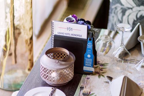 a table topped with a box of food and a plate at Grand Hotel Monopole in Valkenburg