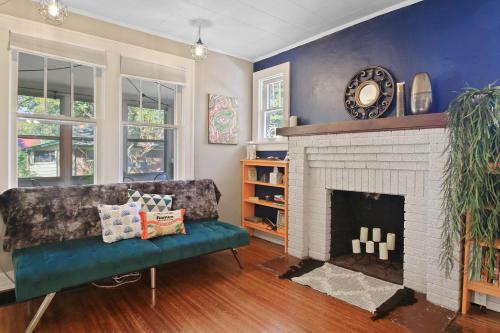 a living room with a couch and a fireplace at Bohemian Bungalow Pac-Man, walk downtown, pet friendly in Columbia