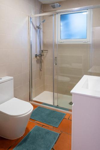a bathroom with a shower and a toilet and a sink at Caniçada House - Gerês in Vieira do Minho